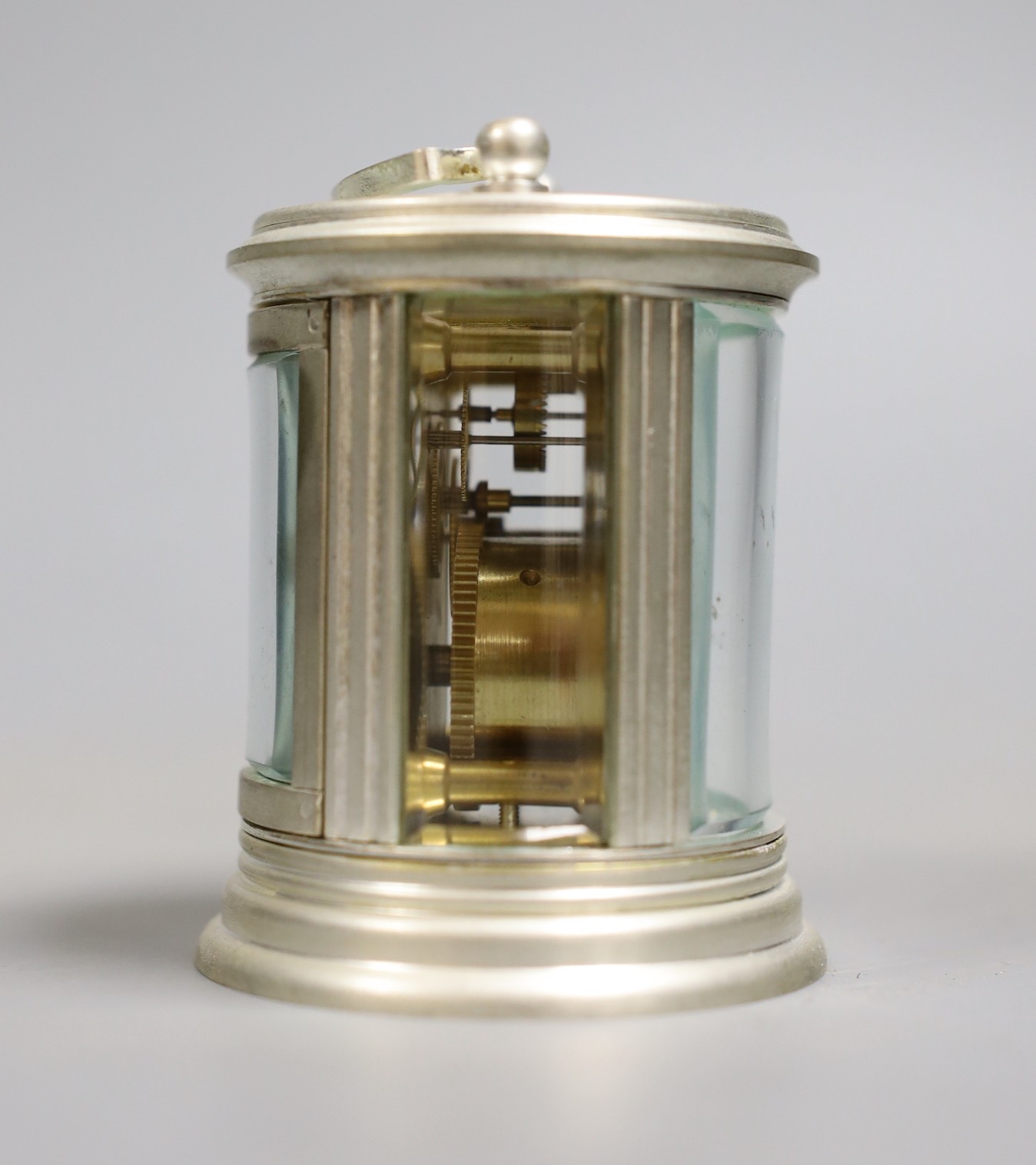 A circular plated carriage clock with key and a Victoria Cross gent's wristwatch